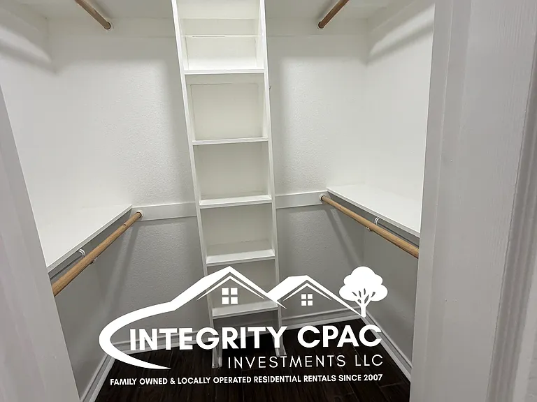 Spacious walk-in closet with white shelving 214 Fair, Integrity CPAC LLC