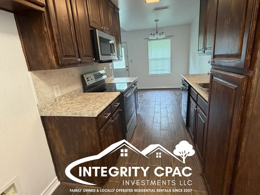 Renovated kitchen with dark cabinets and tile floor - rental 214 Fair, Integrity CPAC LLC