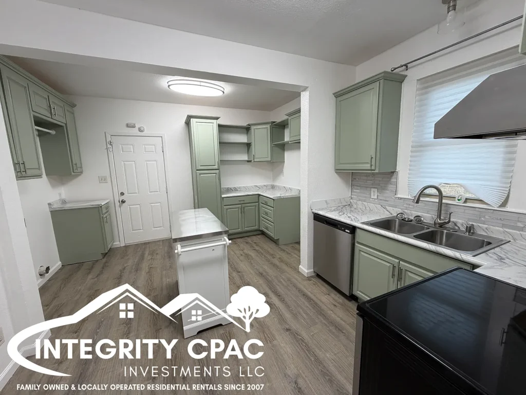 Remodeled kitchen, green cabinets, island in home rental