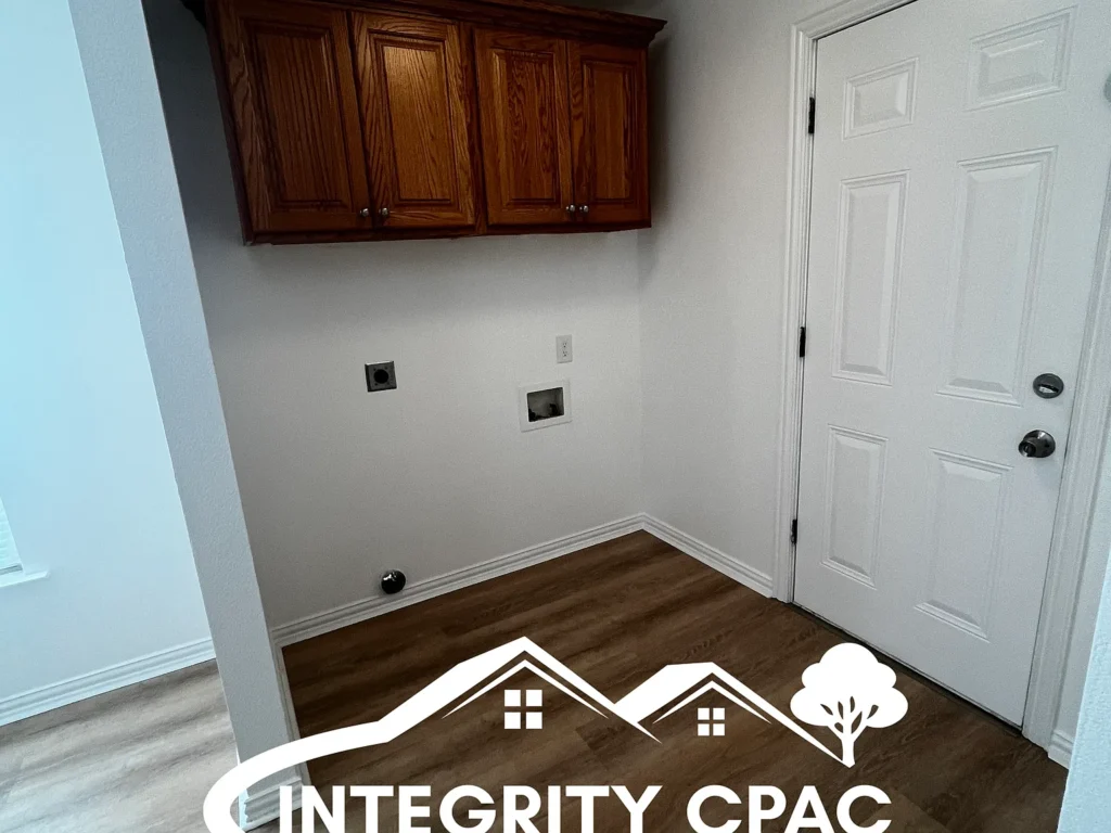 Nice laundry room with dark cabinets and space for full-size washer and dryer, 1415 Lanius in Gainesville TX by Integrity CPAC