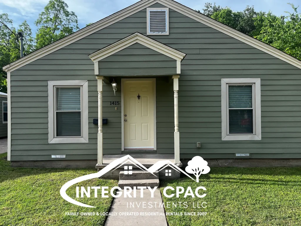 Cute green sided front exterior view of home with green lawn, rental home 1415 Lanius in Gainesville Texas by Integrity CPAC Investments