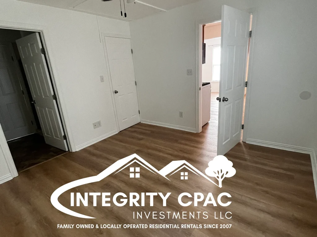 Spacious bedroom, white walls and wood floors 1415 Lanius by Integrity CPAC LLC